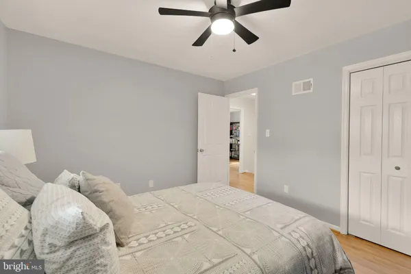 a bedroom with a large bed and a chandelier