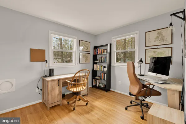 a view of a workspace with furniture and a window