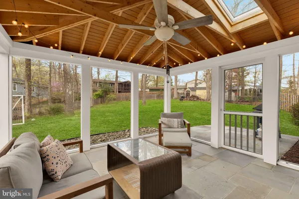 a roof deck with couch and chairs
