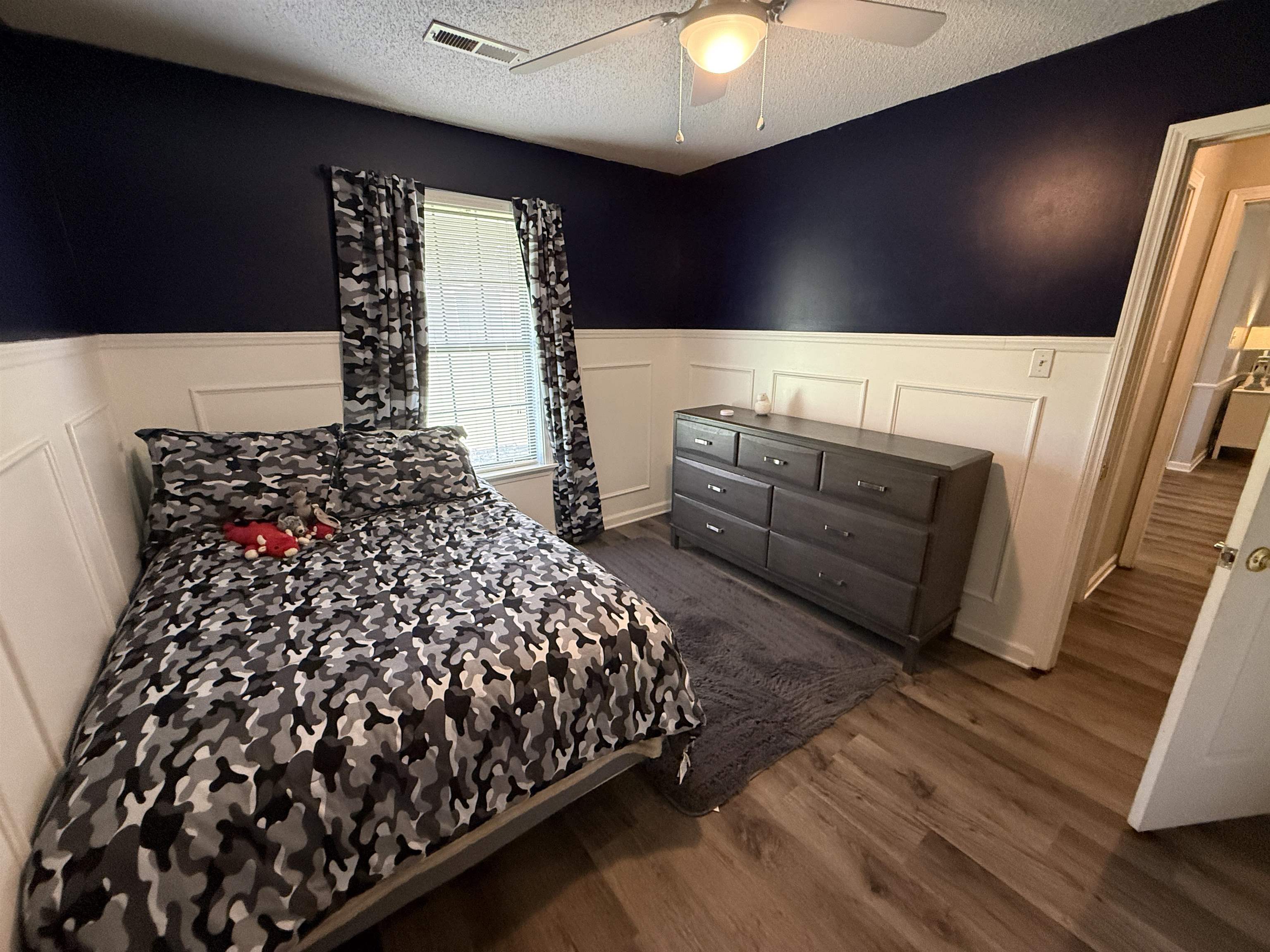 185 Mignon Road Atoka, TN 38004 - Photo 24 of 34 Interior room featuring wainscoting and dark accent wall