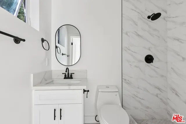 a bathroom with a toilet sink and a shower