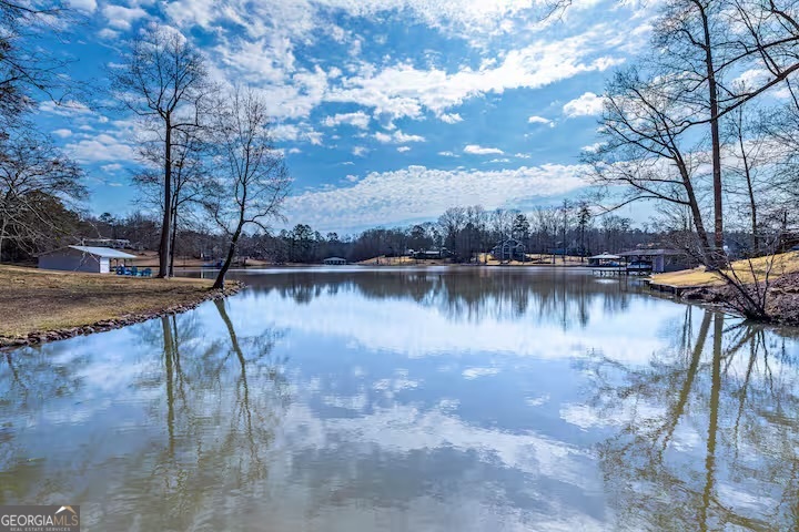 68 Franklin Road Eatonton, GA 31024 - Photo 7 of 28 a view of a lake with houses in the back