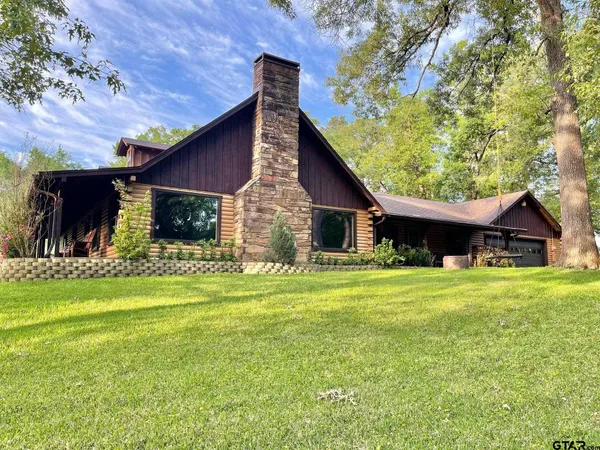 a front view of house with a garden and patio