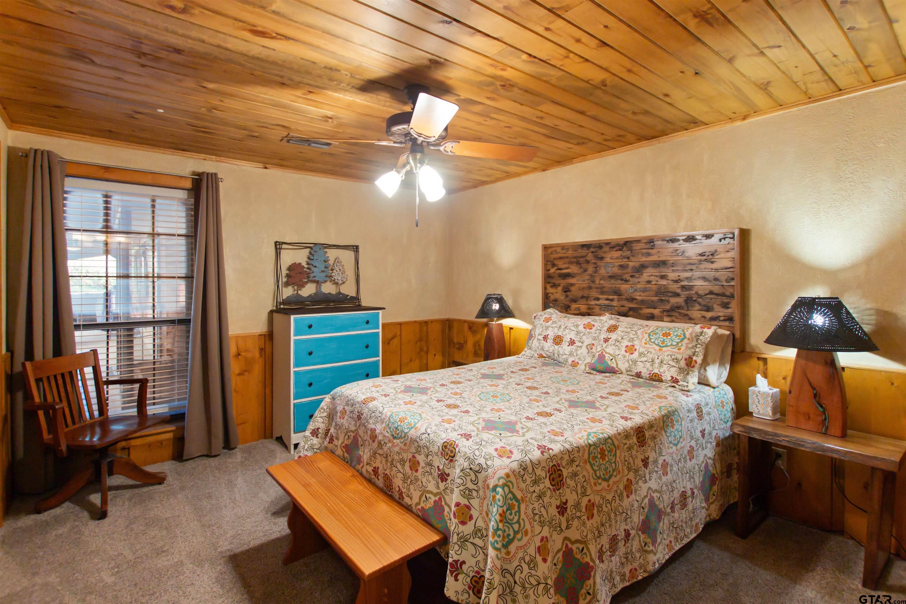 782 Rosie Wady Road Gladewater, TX 75647 - Photo 11 of 41 a bedroom with a bed and wooden floor