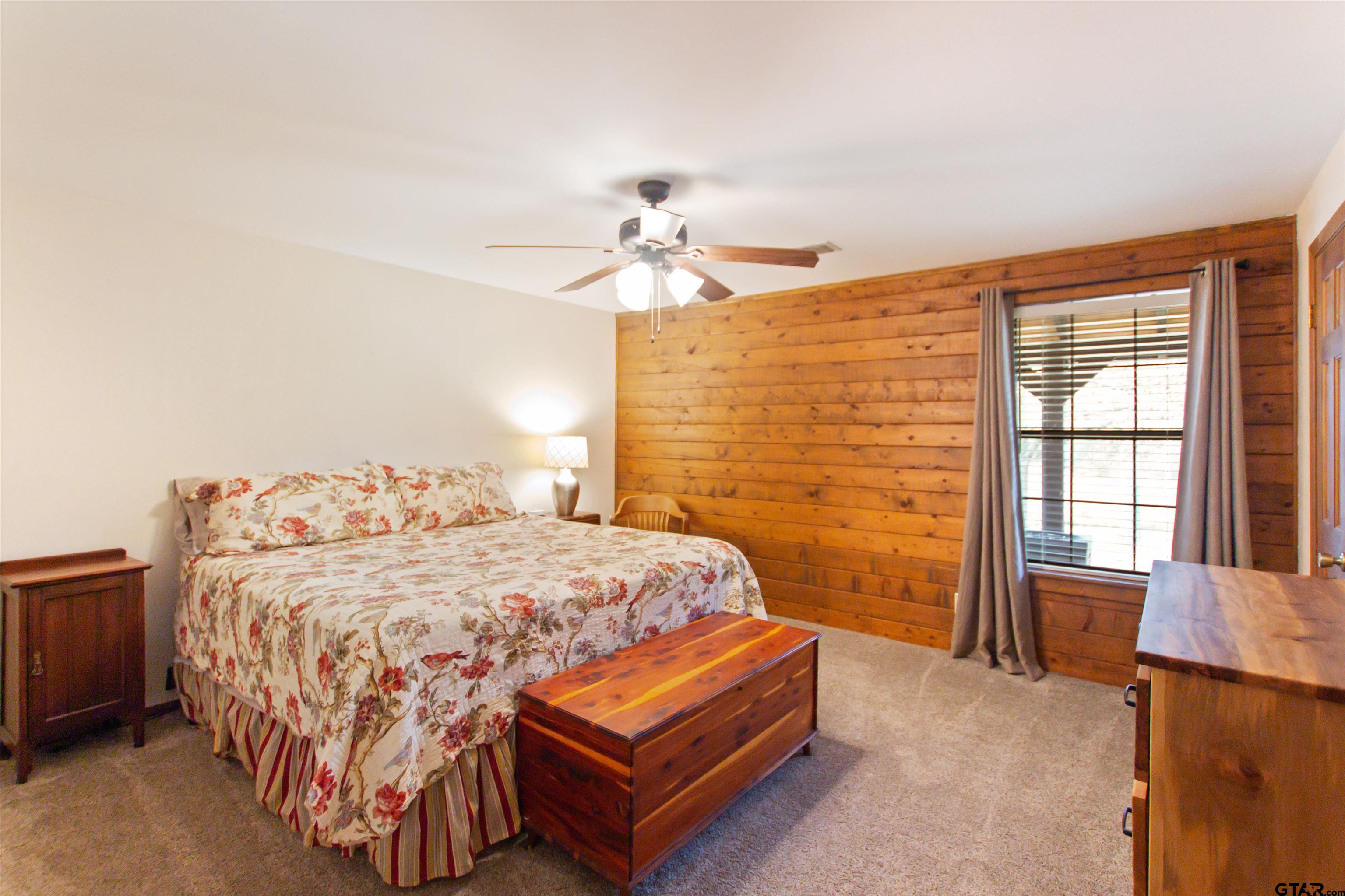 782 Rosie Wady Road Gladewater, TX 75647 - Photo 13 of 41 a bedroom with a bed and a dresser with rug