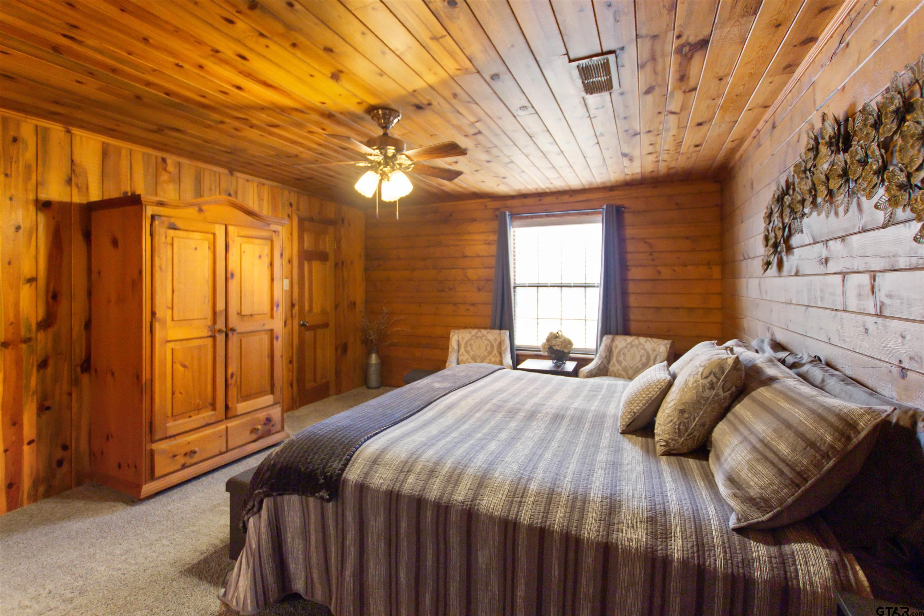 782 Rosie Wady Road Gladewater, TX 75647 - Photo 18 of 41 a bedroom with a bed and a chandelier