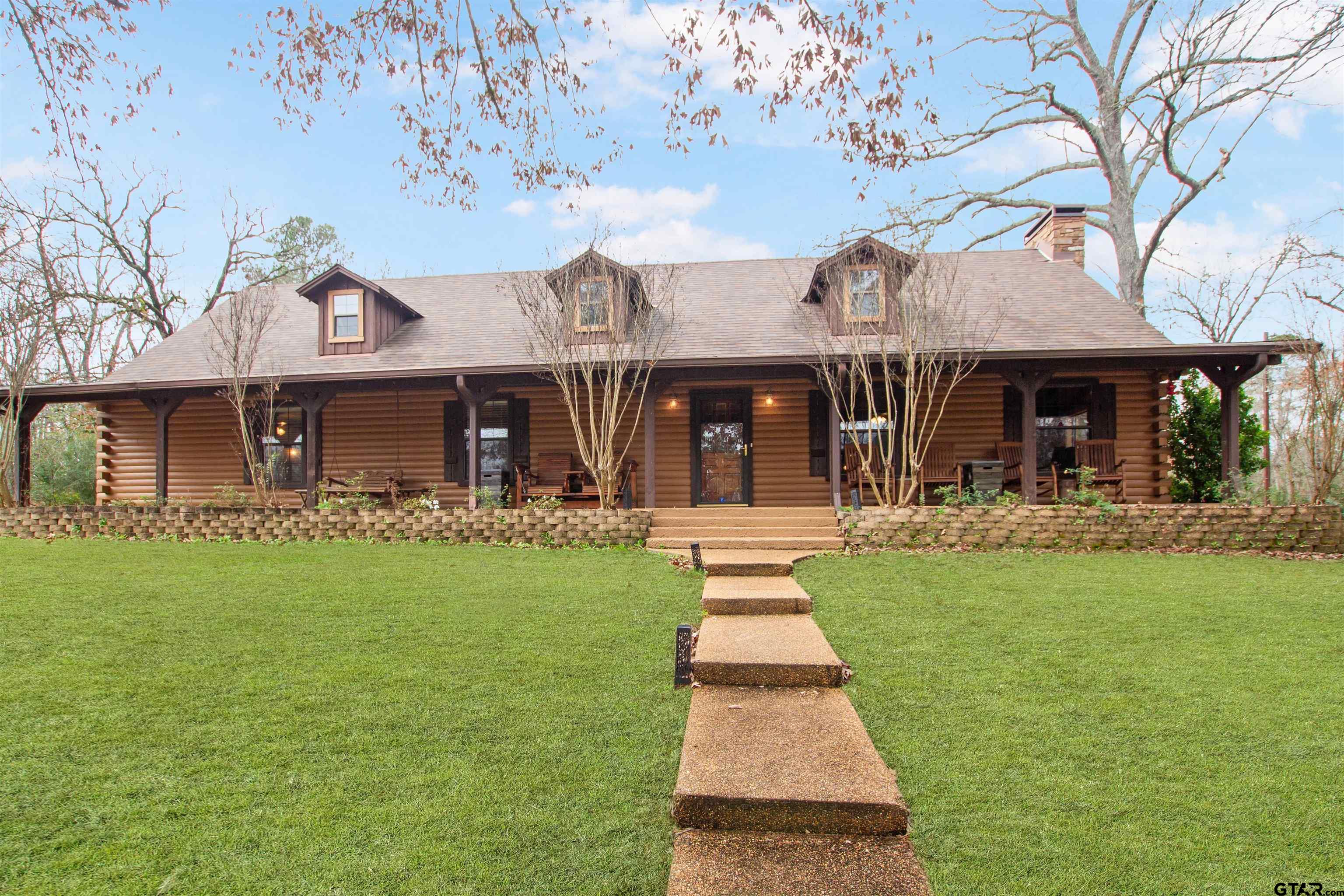 782 Rosie Wady Road Gladewater, TX 75647 - Photo 2 of 41 a front view of a house with a garden