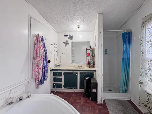 a spacious bathroom with a sink vanity and a mirror