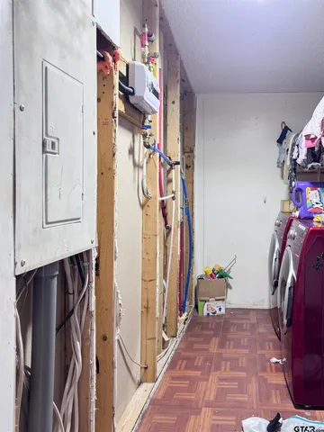a view of walk in closet with clothes