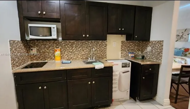a kitchen with a sink and cabinets