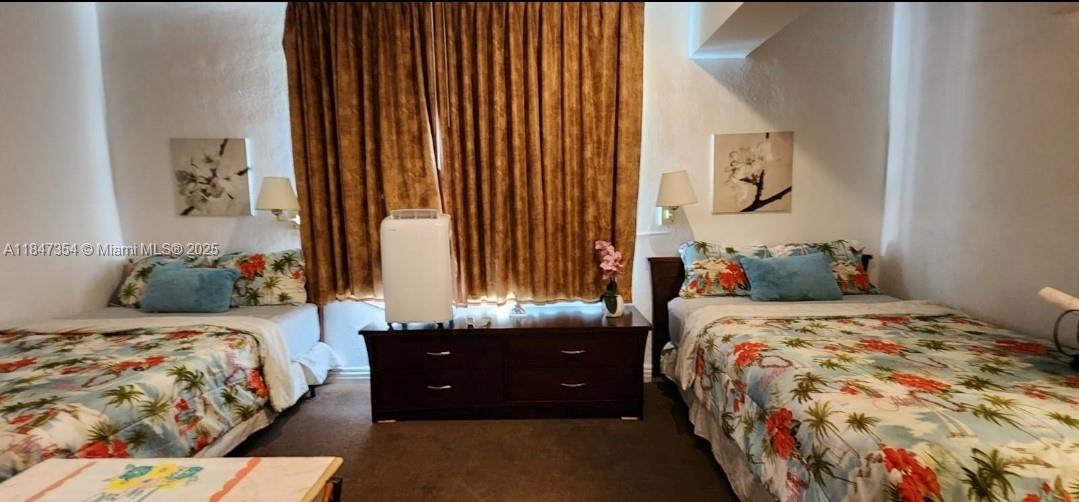 6345 Collins Avenue, Unit PH21 Miami Beach, FL 33141 - Photo 4 of 8 a bedroom with a bed and a window