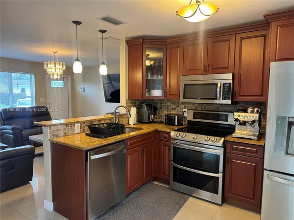 a view of a backyard with furniture and a patio
