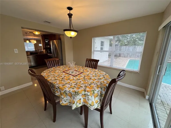 a dining room with furniture and window
