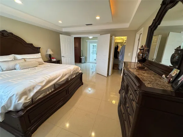 a bedroom with a bed and a walk in closet