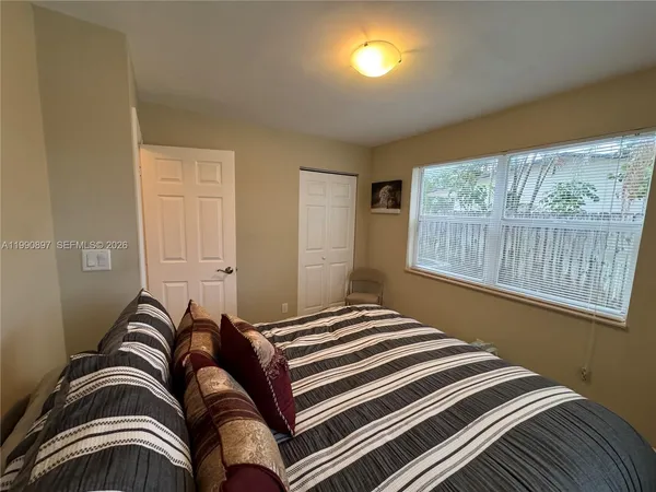 a bedroom with a bed and a window