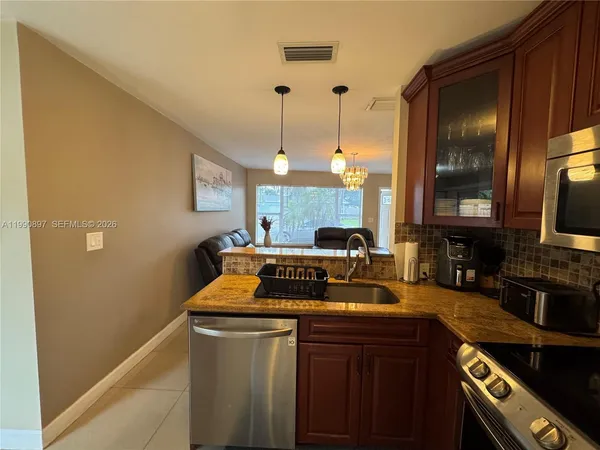 a kitchen with a sink and a stove top oven
