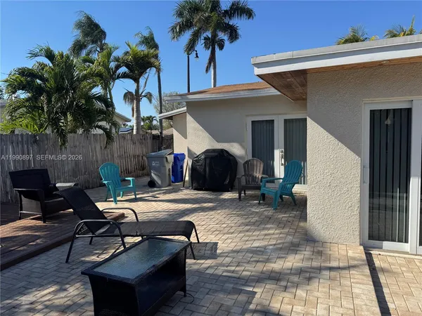 a view of a backyard with furniture and a patio