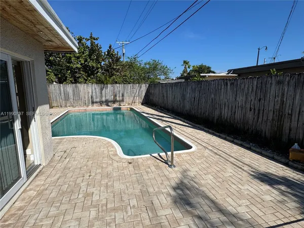 a view of a house with a cars back yard