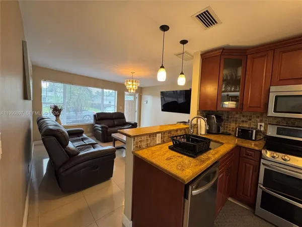 a kitchen with a stove a sink and a refrigerator