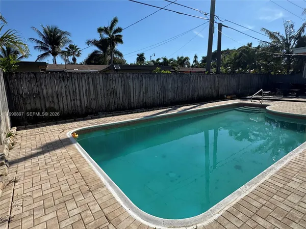a view of a backyard with a swimming pool