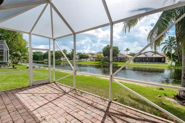 a view of a room with wooden floor and window