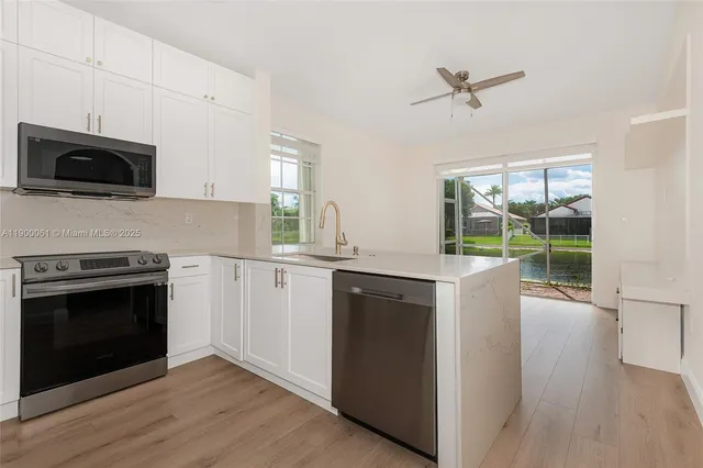 a kitchen with a sink and a large window