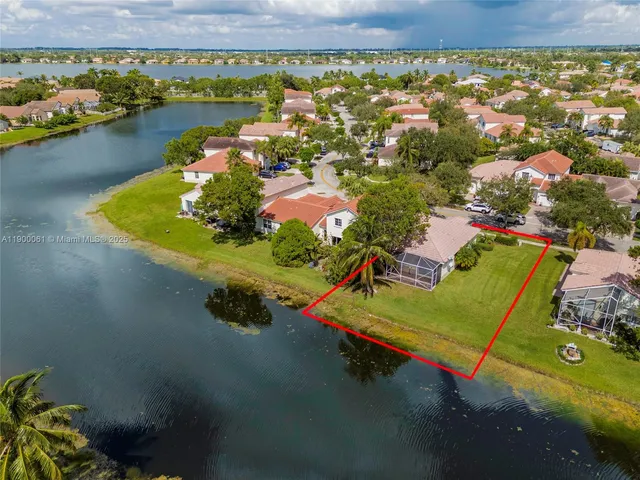 an aerial view of a house with a lake view
