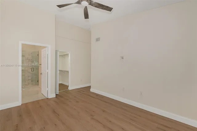 a view of walk in closet with empty racks