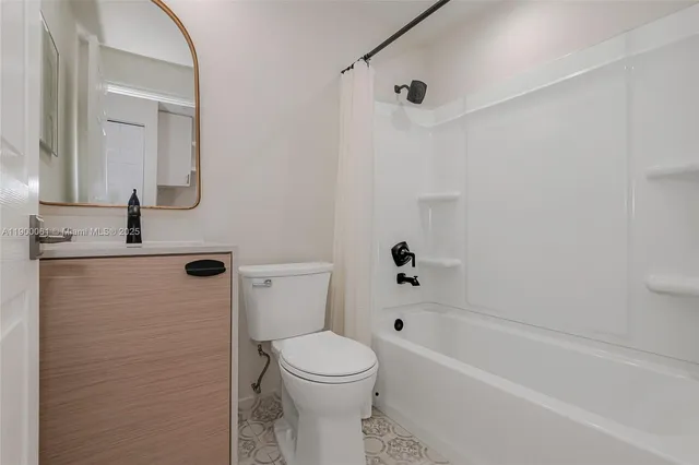 a view of bathroom with a sink mirror and shower
