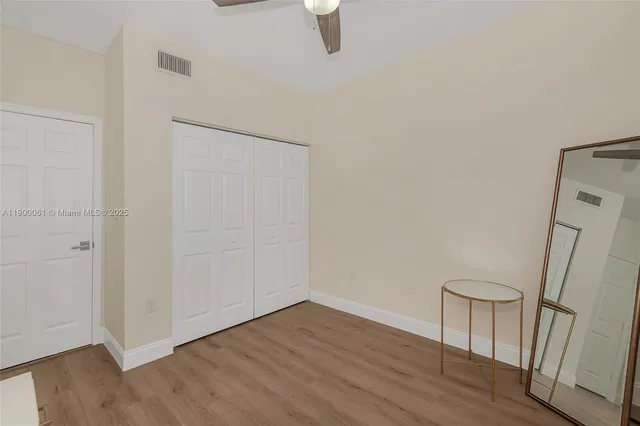 a view of a room with wooden floor