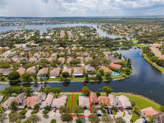 an aerial view of residential house with outdoor space and ocean view