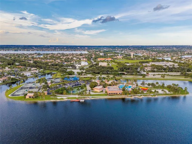 a view of a lake with couches in the patio