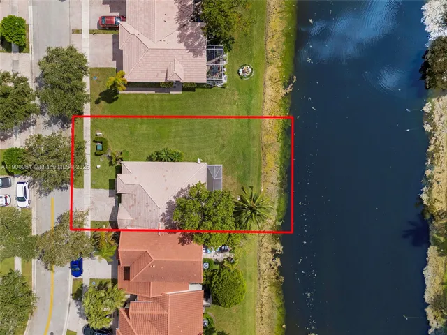 a front view of a house with fountain and garden