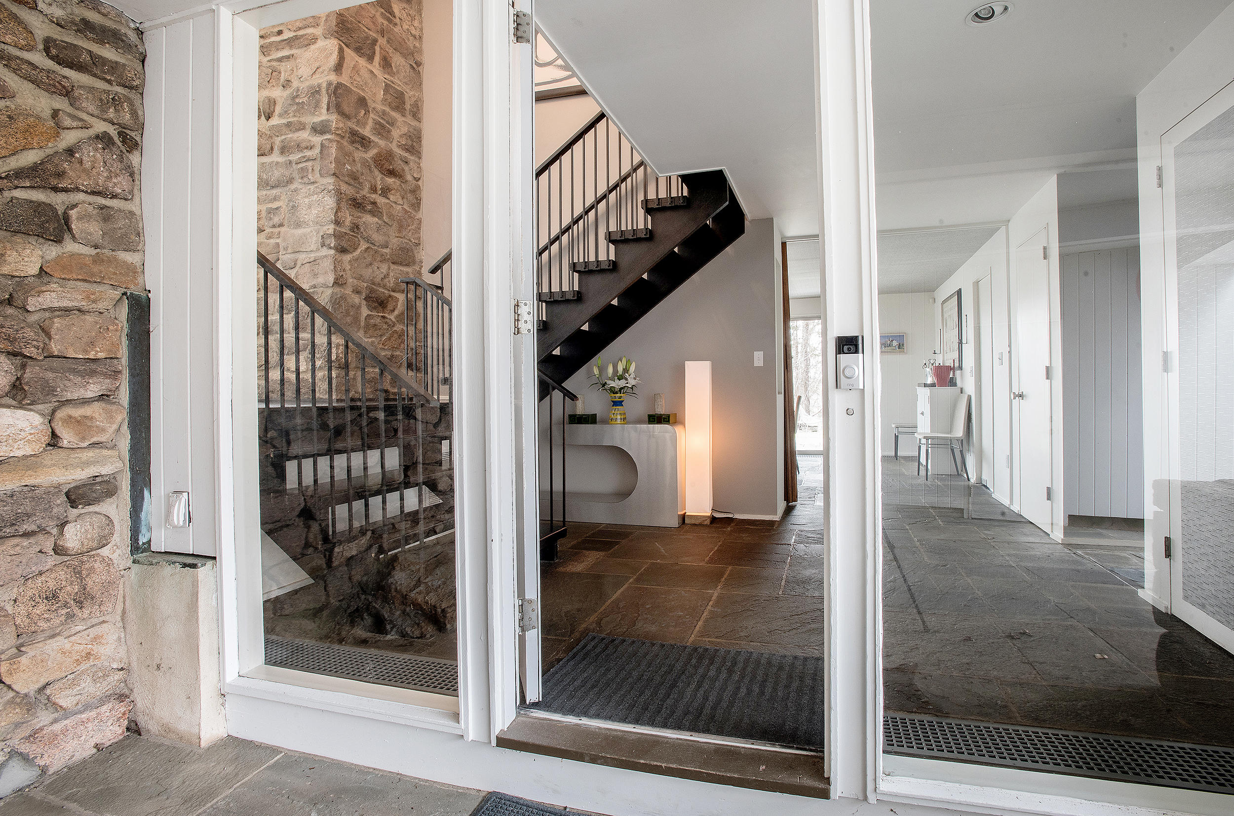 46 Benedict Hill Road New Canaan, CT 06840 - Photo 38 of 50 a view of a hallway with wooden floor and glass door