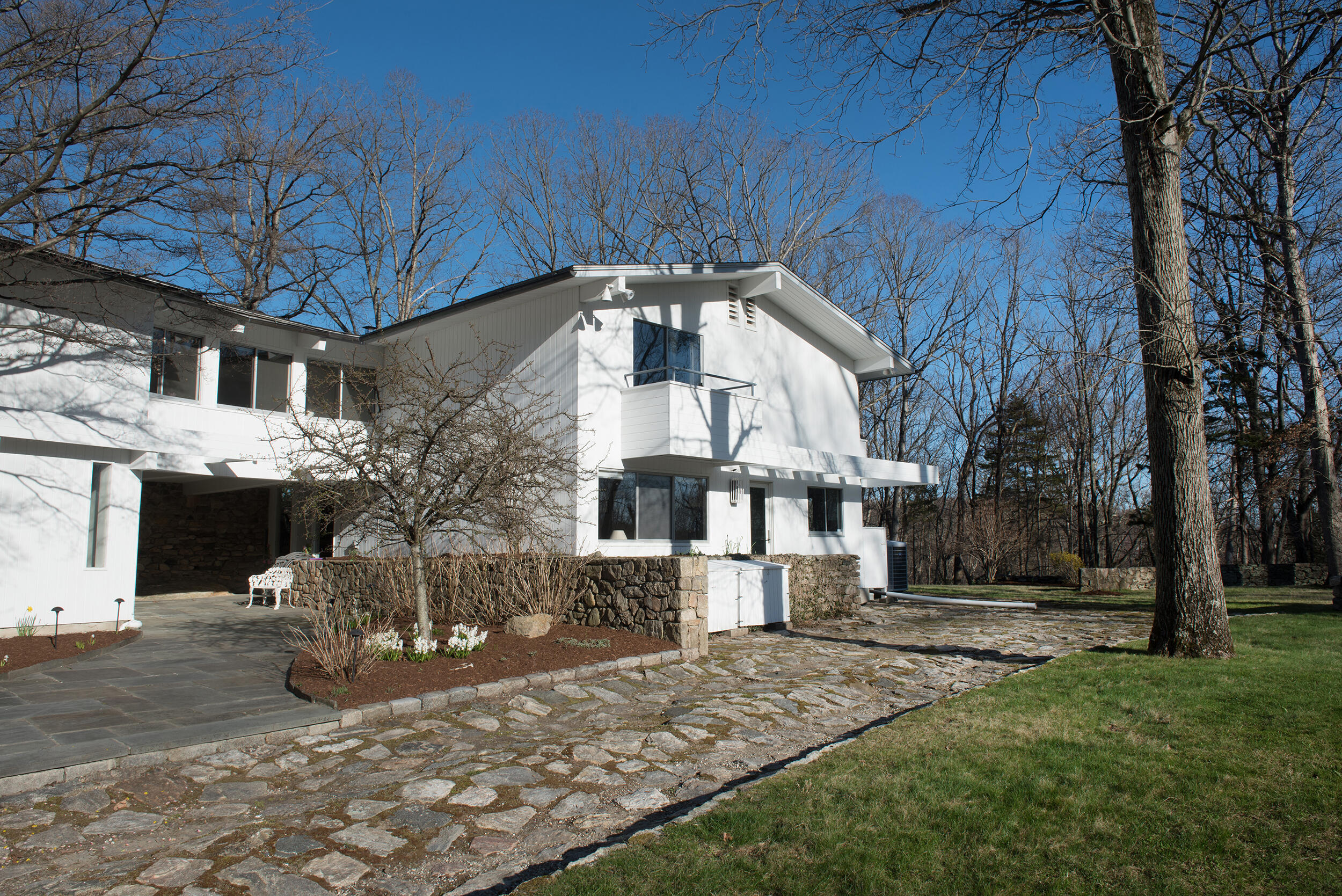 46 Benedict Hill Road New Canaan, CT 06840 - Photo 48 of 50 a front view of a house with a yard