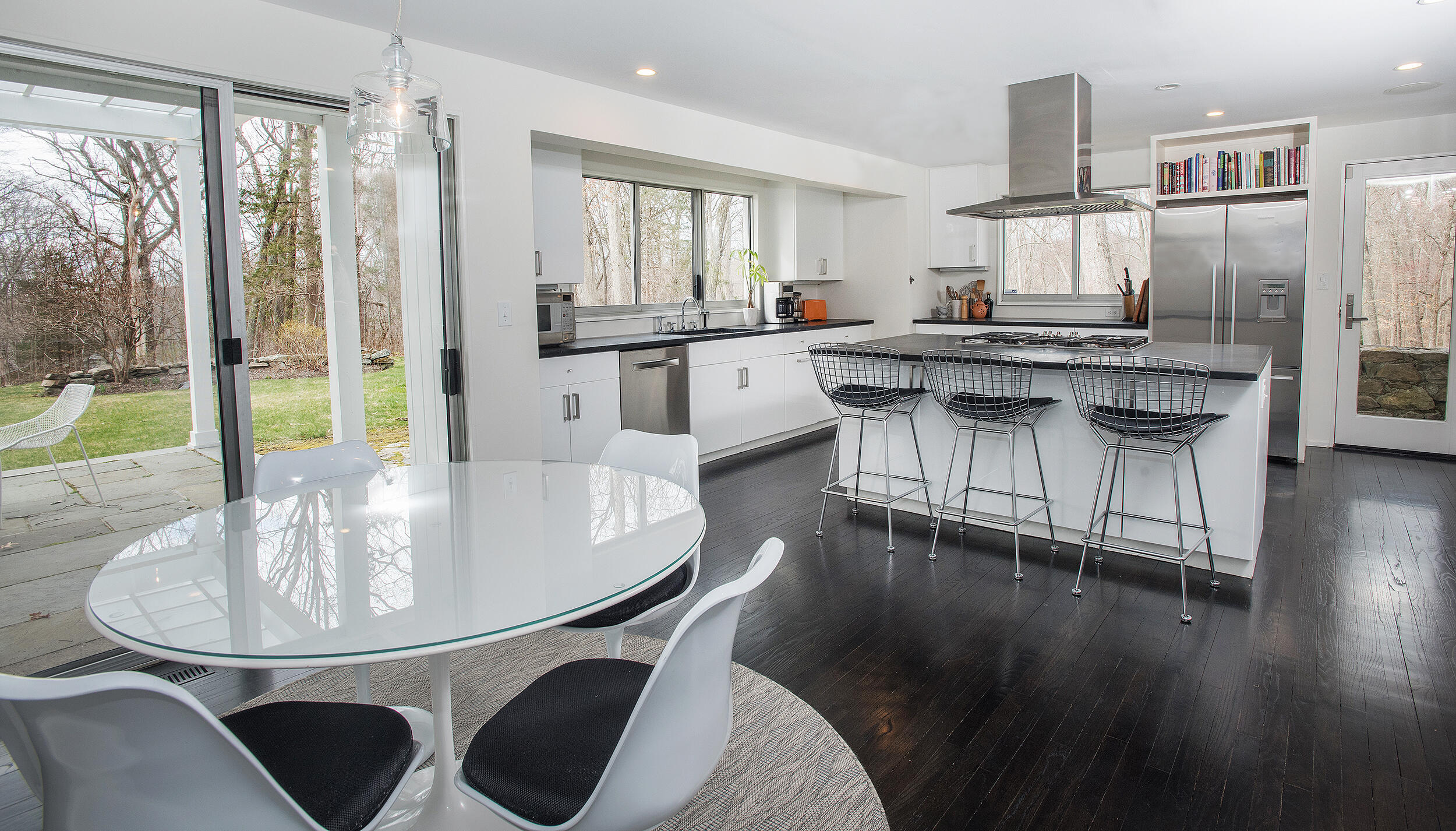 46 Benedict Hill Road New Canaan, CT 06840 - Photo 9 of 50 a kitchen with a dining table chairs and white appliances