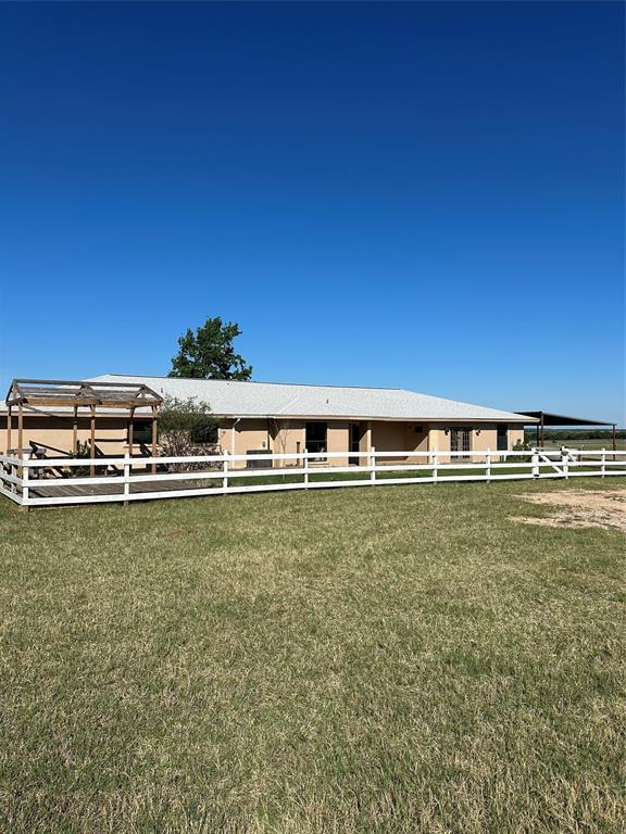 1740 Highway 2247 Comanche, TX 76442 - Photo 2 of 36 a view of a large pool with lawn chairs and wooden fence