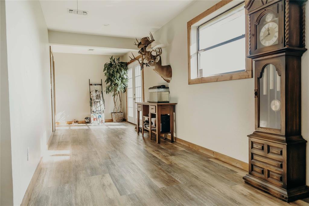 1740 Highway 2247 Comanche, TX 76442 - Photo 21 of 36 a view of a hallway with wooden floor and staircase