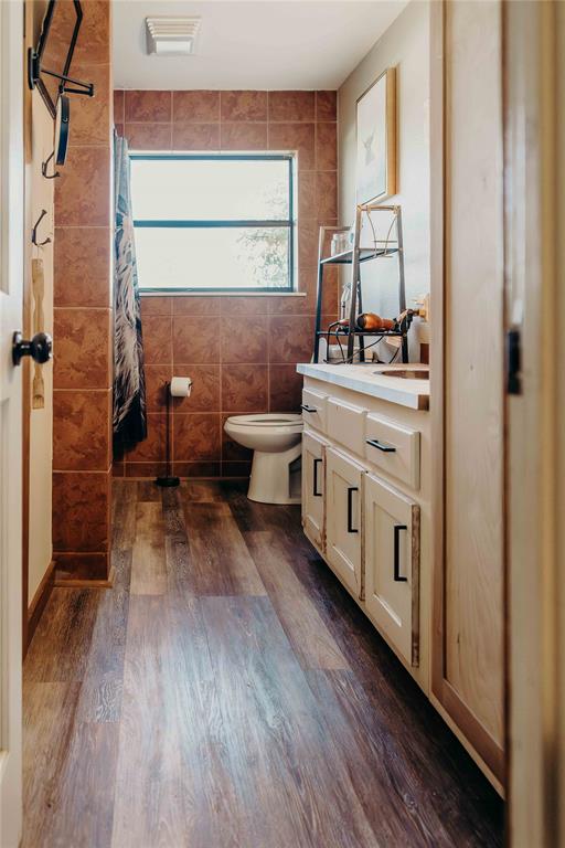 1740 Highway 2247 Comanche, TX 76442 - Photo 25 of 36 a room with stainless steel appliances white cabinets and wooden floor