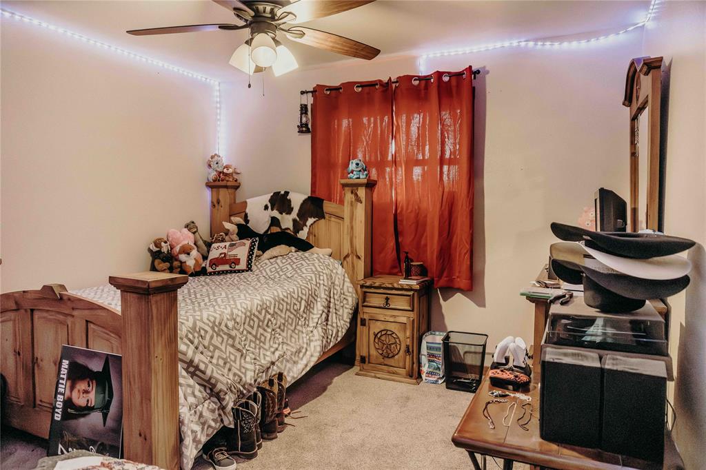 1740 Highway 2247 Comanche, TX 76442 - Photo 28 of 36 a bed room with a bed and a chair