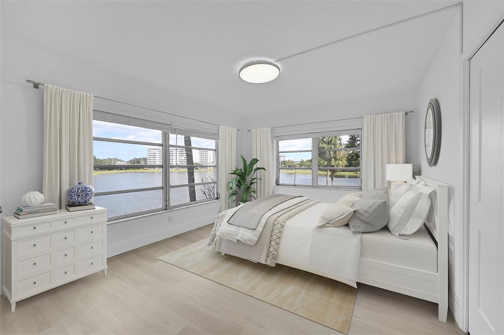 2801 North Palm Aire Drive, Unit 201 Pompano Beach, FL 33069 - Photo 11 of 19 a bedroom with a bed and a window