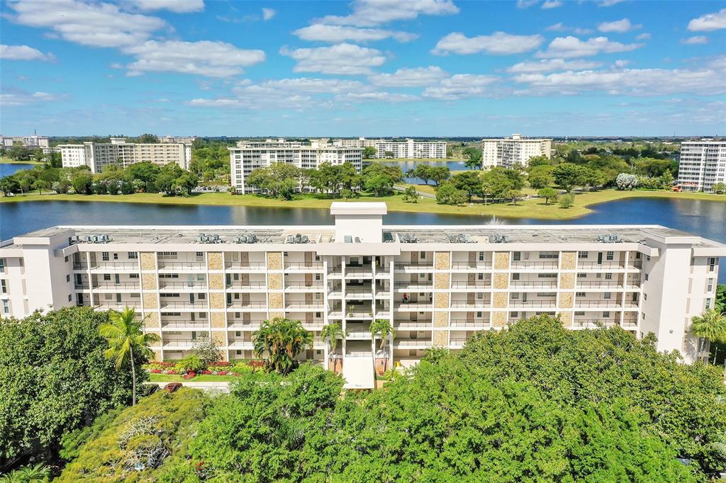 2801 North Palm Aire Drive, Unit 201 Pompano Beach, FL 33069 - Photo 18 of 19 a view of a large building with a lake view