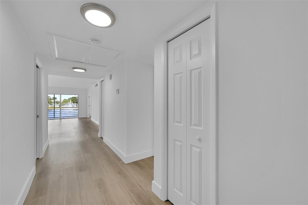 2801 North Palm Aire Drive, Unit 201 Pompano Beach, FL 33069 - Photo 4 of 19 a view of a hallway with wooden floor