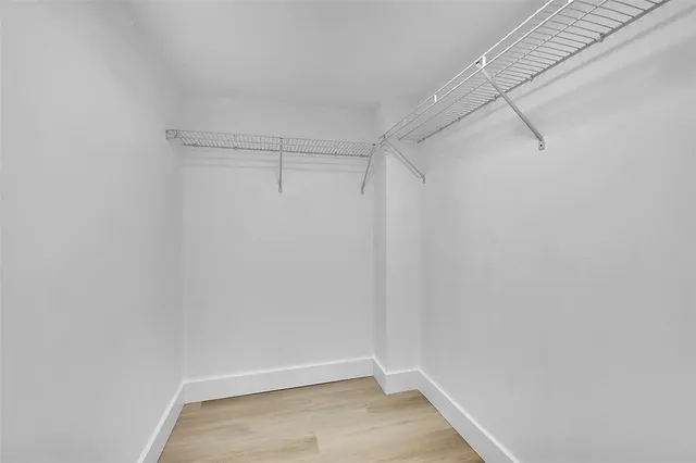 a bathroom with a toilet sink vanity and mirror