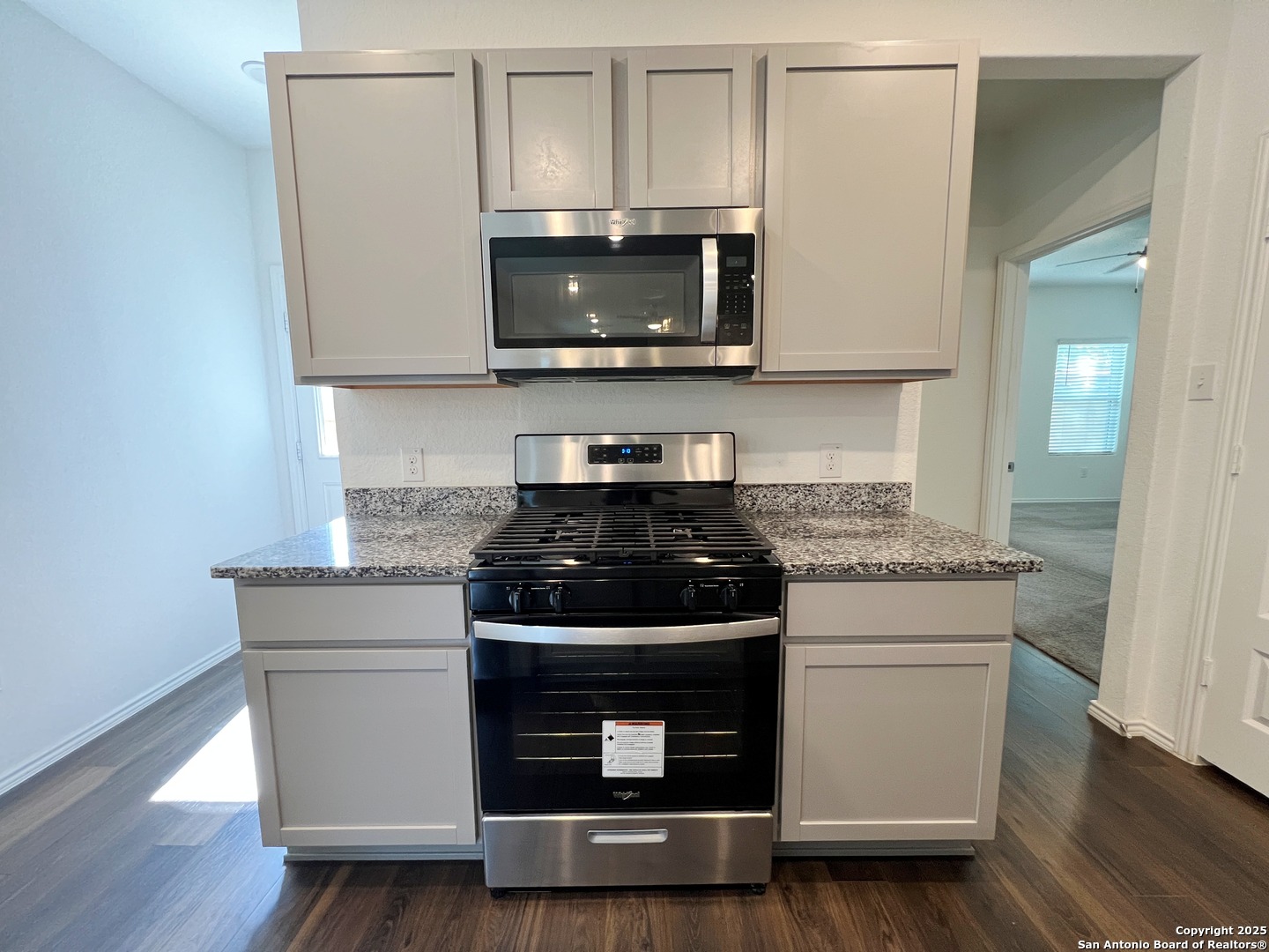 4422 Chandler Road, Unit 4 San Antonio, TX 78222 - Photo 11 of 31 a kitchen with granite countertop a stove and a microwave