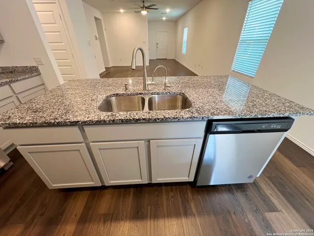 a kitchen with stainless steel appliances granite countertop a sink and a granite counter tops