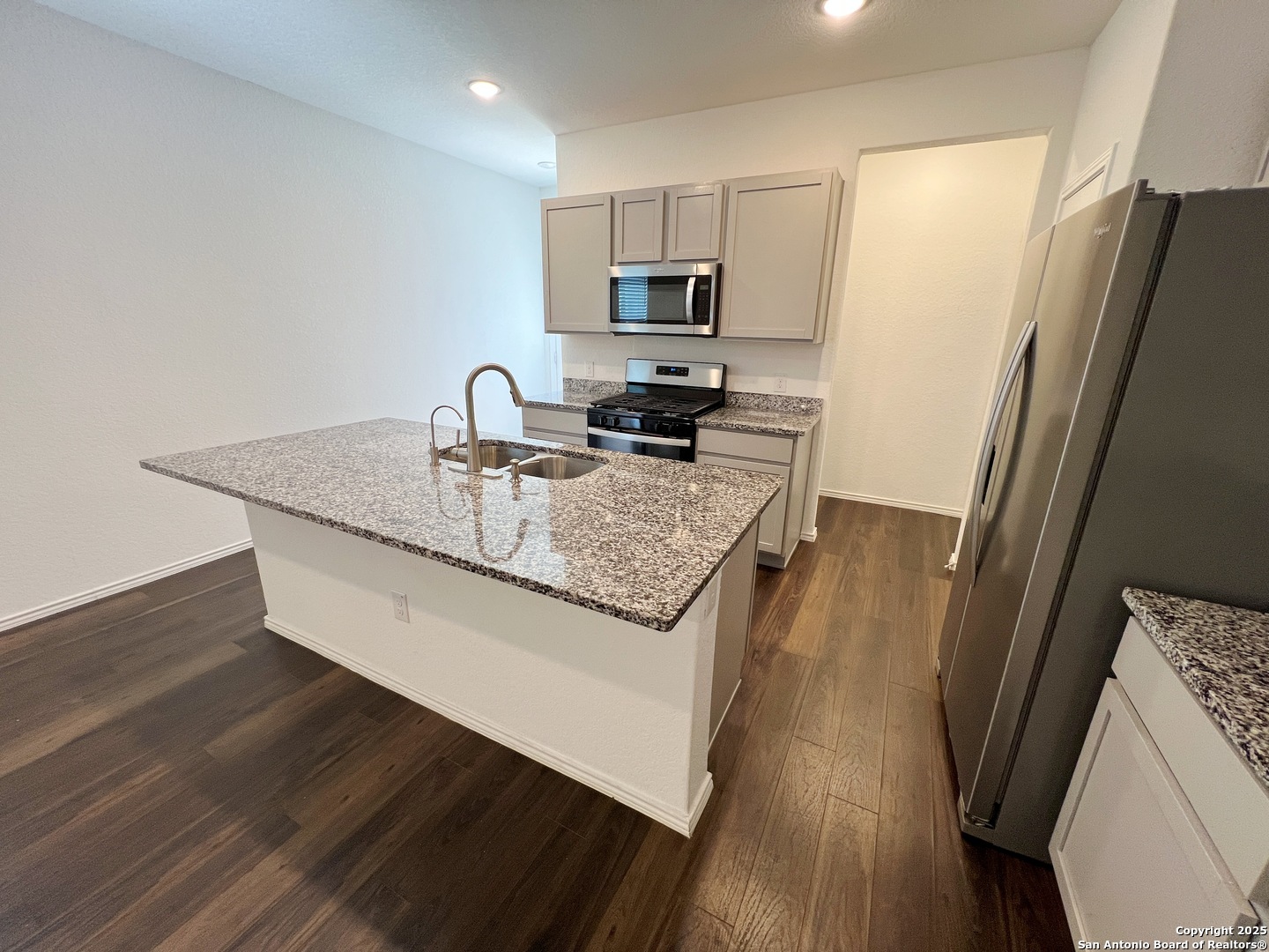 4422 Chandler Road, Unit 4 San Antonio, TX 78222 - Photo 15 of 31 a kitchen with stainless steel appliances granite countertop a refrigerator a stove and a wooden floors