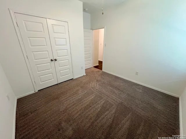 an empty room with closet area
