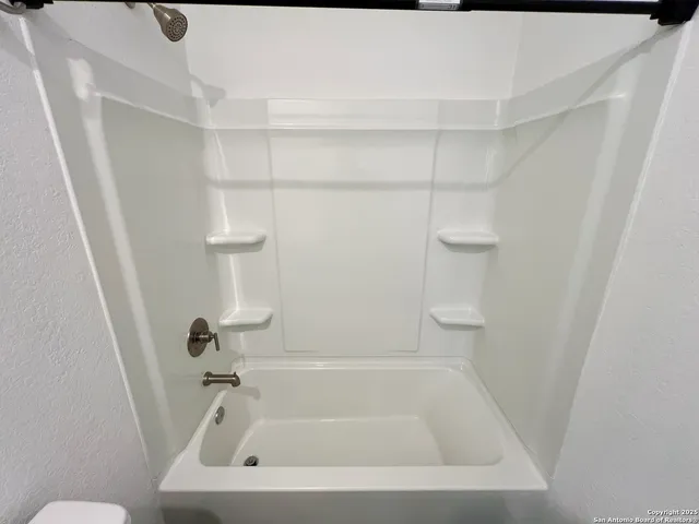 a bathroom with a white bath tub