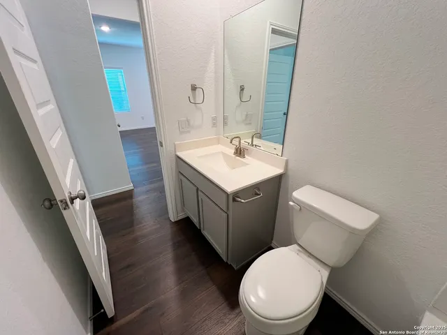 a bathroom with a toilet sink and mirror